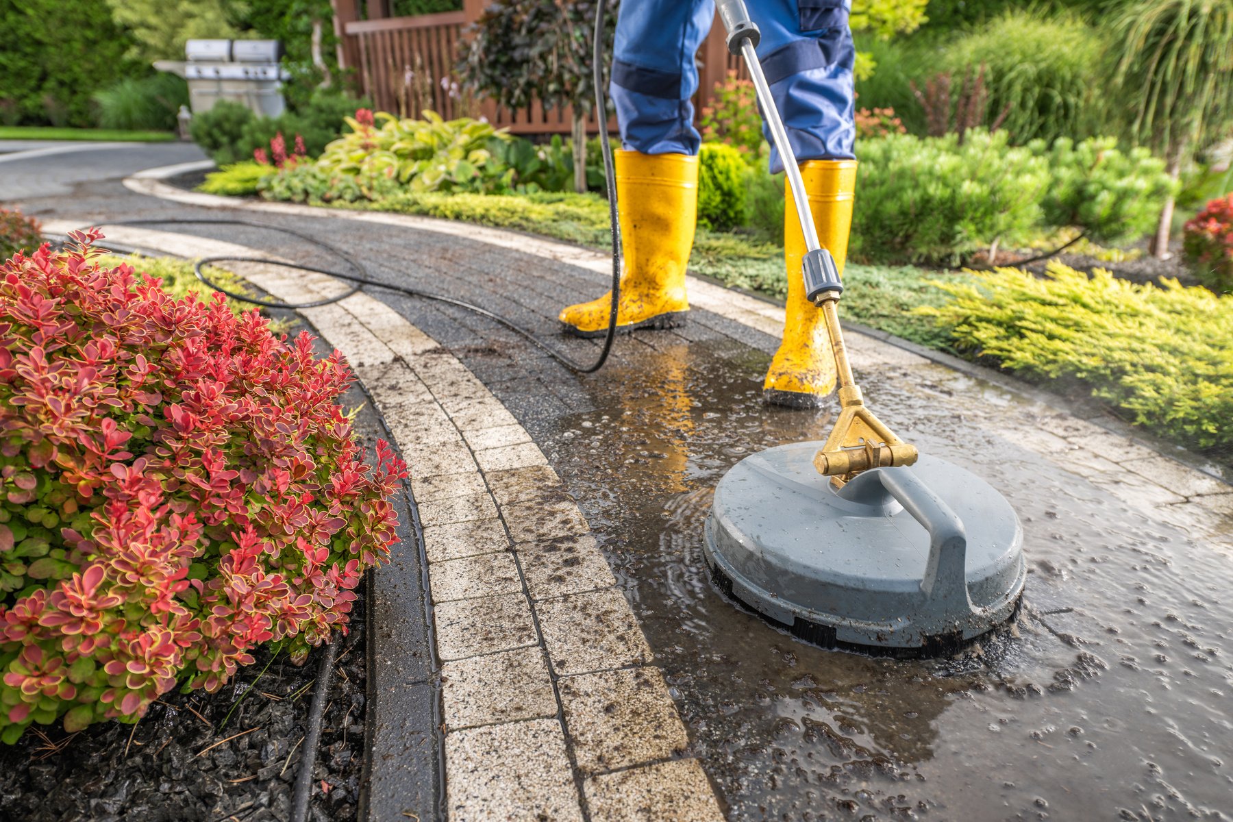 Garden Worker Pressure Washing Decorative Bricks Garden Paths